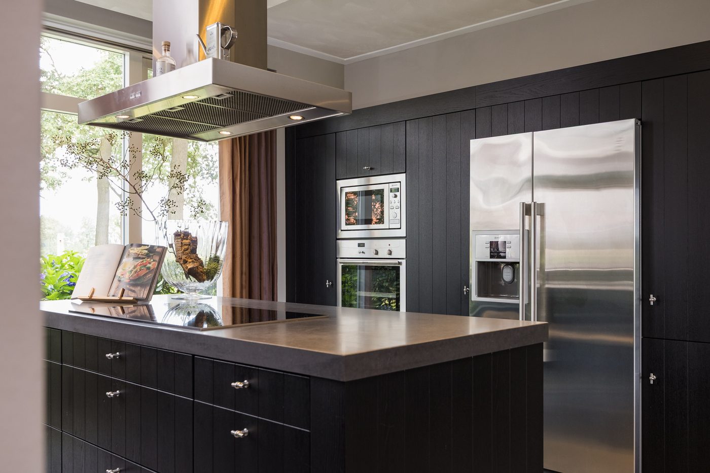 De kastenwand met combi-oven, magnetron en Amerikaanse koel-vriescombinatie